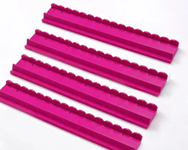 Pink wooden rack with scalloped edges, 20 inches long.