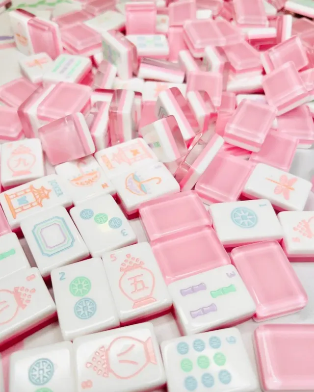 Petal pink Mahjong tiles with white pips and rounded edges.