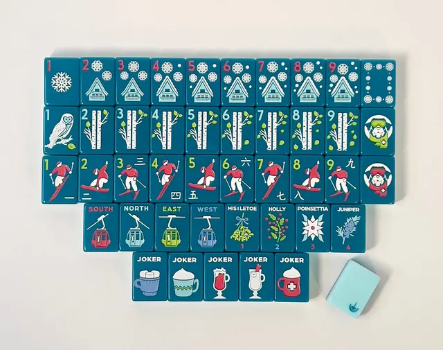 Apres Ski Tiles by Charleston Mahjong Club frosted white porcelain with ski-lodge motifs.
