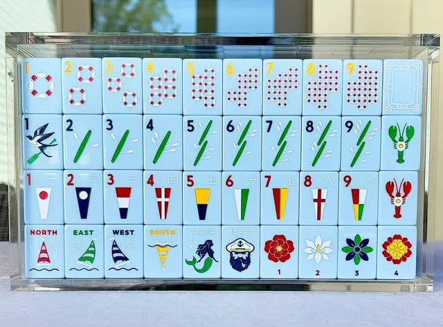 Ivory yacht club mahjong tiles with sea-glass green and navy accents.