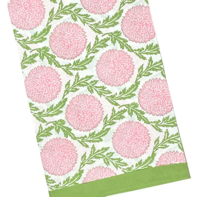 Pink and green floral vines on a soft tablecloth.