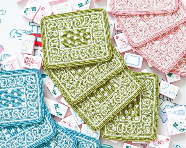 Hand beaded paisley coasters in assorted colors with felt backing.
