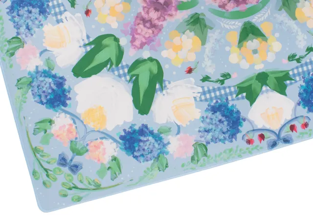 Powder blue garden party mat with botanical motif and stitched border.