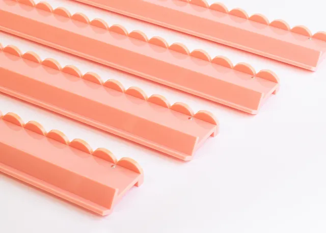 Miss Mahjong Peach Sorbet scalloped acrylic racks for mahjong tiles.
