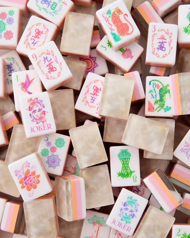 Perlescent mahjong tiles with iridescent glaze and smooth edges.