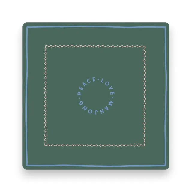 Dark green mat with a bold border and soft fabric surface.